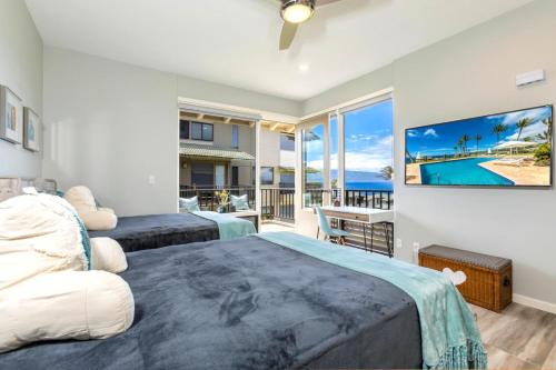 a bedroom with two beds and a view of the ocean at Kapalua Bay 31G432B2 FREE CAR KBM Resorts in Honokahua