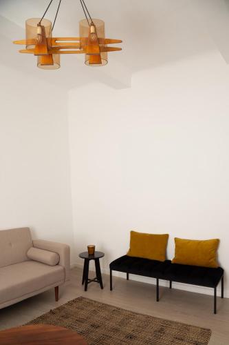a living room with a couch and a chair at Maison de village Arty et terrasse au calme in Lourmarin