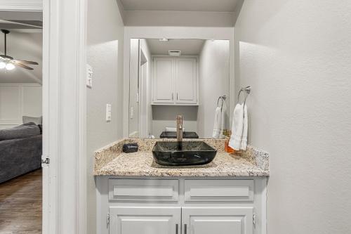 a bathroom with a black sink in a room at Cosy Waterfront Home in Rockwall