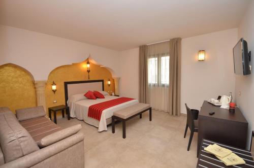 a hotel room with a bed and a couch at RIAD Comfort Rooms in San Vito lo Capo