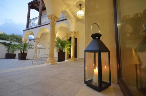 a lantern on the side of a building at RIAD Comfort Rooms in San Vito lo Capo