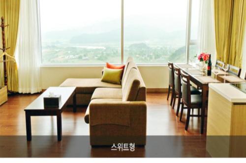 a living room with a couch and a table at Mungyeong saejae Resort in Mungyeong