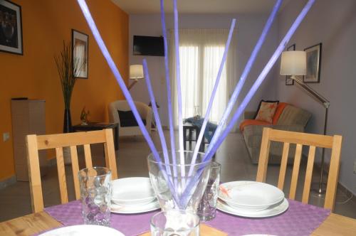 a table with plates and a vase on top of it at Aegean View Villa in Loutraki
