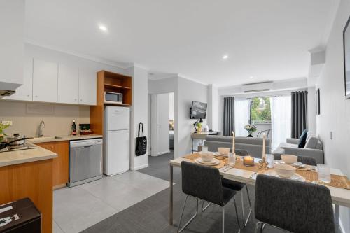 a kitchen and living room with a table and chairs at Quest Mont Albert in Box Hill