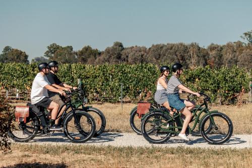 a group of people riding bikes down a road at BIG4 Rutherglen Holiday Park in Rutherglen