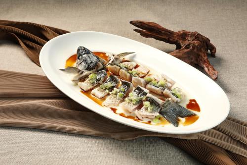 a white plate of food on a table at Sheraton Zhongshan Hotel in Zhongshan