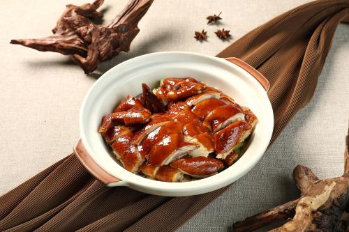 a bowl of food sitting on top of a table at Sheraton Zhongshan Hotel in Zhongshan