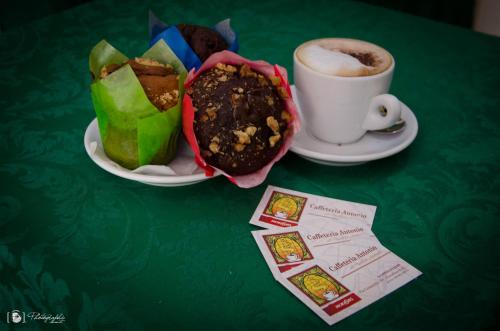 a table with a plate of food and a cup of coffee at Rescio's Rooms in Cavallino di Lecce