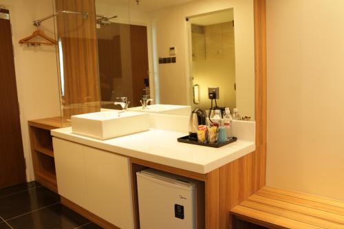 a bathroom with a sink and a mirror at Amerin Hotel Johor Bahru in Johor Bahru