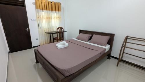 a bedroom with a bed in a room at Waveo Homestay Polhena in Matara