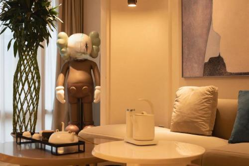 a living room with a doll sitting on a couch at New Friendship Hotel in Luoyang