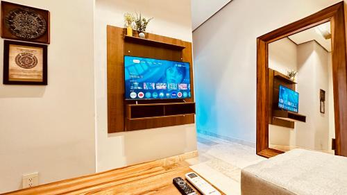 a living room with a tv on the wall at Jungle Guardian - Rooftop Pool & Beach Club in Zona Hotelera Tulum in Tulum