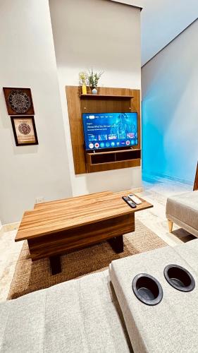 a living room with a table and a tv at Jungle Guardian - Rooftop Pool & Beach Club in Zona Hotelera Tulum in Tulum