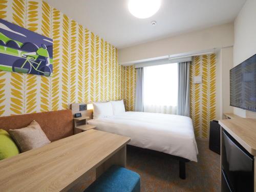 Ένα ή περισσότερα κρεβάτια σε δωμάτιο στο Tabino Hotel Kakogawa Befu Station