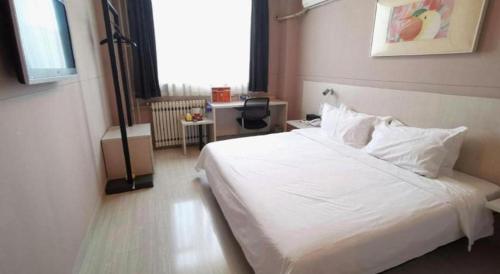 a bedroom with a white bed in a room at Zhangye Pinmu Hotel(Yuncheng Zhongyin Avenue Store) in Yuncheng