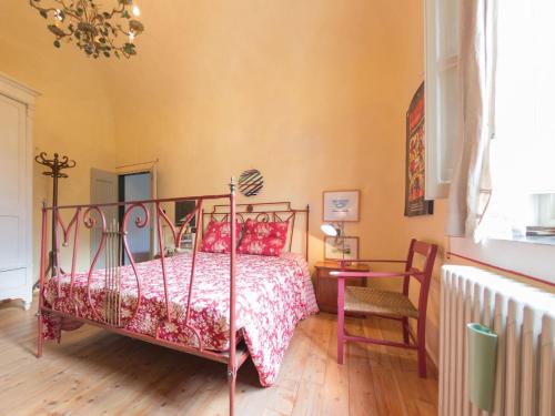 a bedroom with a bed and a table and a chair at Casa Francesca in Finale Ligure