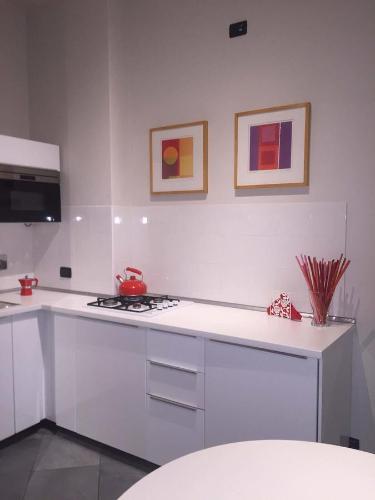 a kitchen with a stove and a white counter top at Residenza Avogadro in Turin