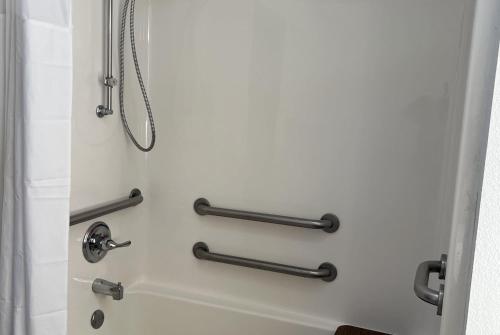 a shower in a bathroom with black towel racks at Days Inn by Wyndham Jamestown in Jamestown