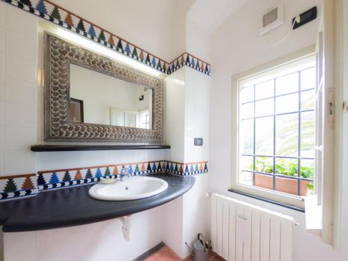 a bathroom with a sink and a mirror at Casa Francesca in Finale Ligure