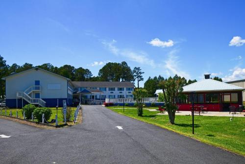 a road in front of a building with a playground at Days Inn by Wyndham Chincoteague Island in Chincoteague