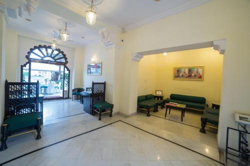 a waiting room with couches and chairs in a building at Garden Hotel - Heritage by HRH Group of Hotels in Udaipur