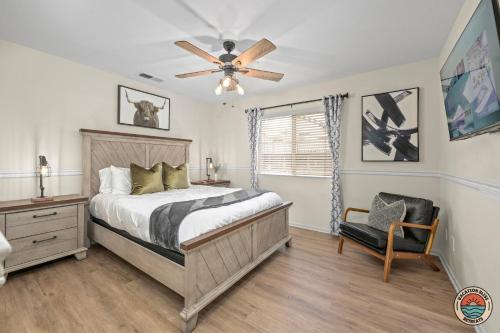 a bedroom with a bed and a ceiling fan at The Ultimate Escape Pool, Slide, Gym plus Games! in El Cajon