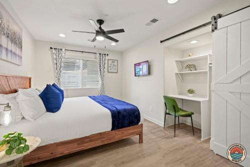 a bedroom with a bed and a ceiling fan at The Ultimate Escape Pool, Slide, Gym plus Games! in El Cajon