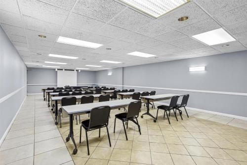 a large room with tables and chairs in it at Spark by Hilton Des Plaines Chicago O'Hare in Des Plaines