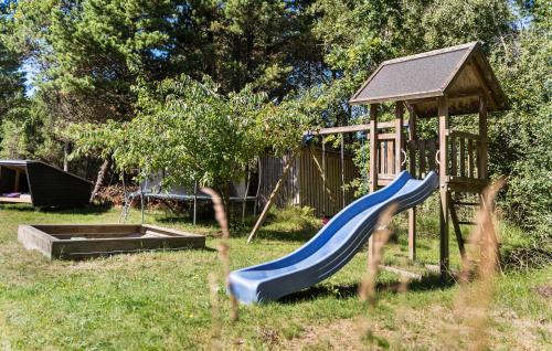 a playground with a blue slide and a gazebo at Holiday Home Kærhøgen Rømø Denm in Rømø Kirkeby