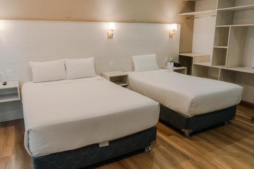 two beds sitting next to each other in a room at HOTEL PIEDRA SANTA - Moquegua in Moquegua
