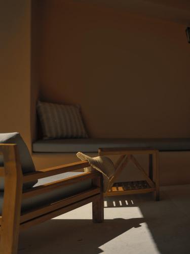 a room with a bed with a bench in the corner at Viceroy at Ombria Algarve in Loulé