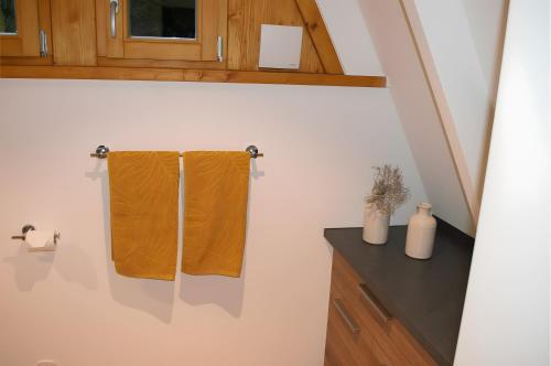 a bathroom with two towels hanging on a wall at Ferienhaus Eulennest in Billerbeck