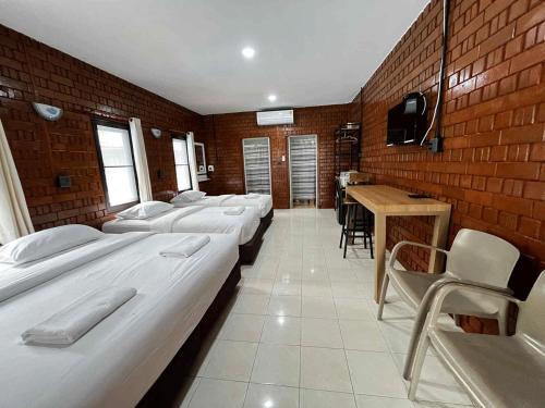 a room with a bunch of beds in it at Ban Krut Resort in Ban Krut