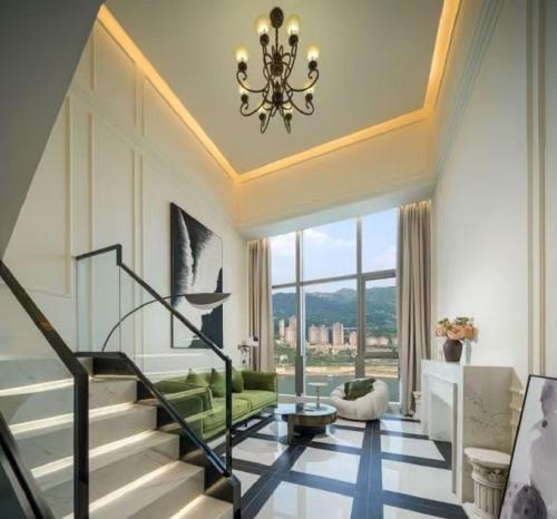 a living room with a staircase and a chandelier at Ouchen International Sky River Hotel (Monument to the people's Liberation Pedestrian Street Store, Chongqing) in Chongqing