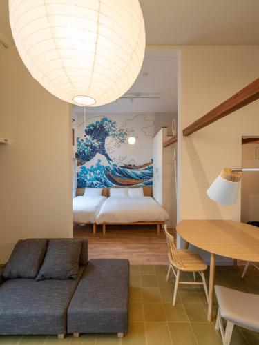 a living room with a large chandelier at Oneness Apartment Akasaka 赤坂 in Fukuoka
