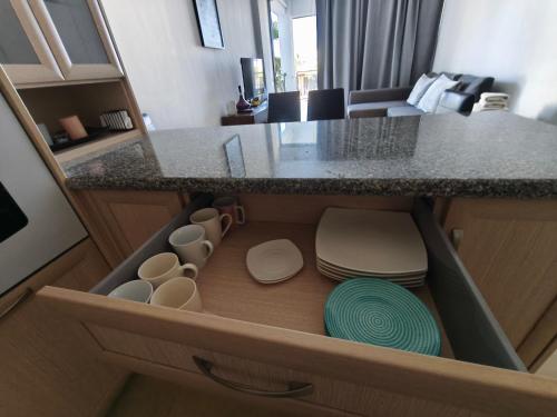 an open drawer in a kitchen with a counter at Danaos Nava in Paphos City