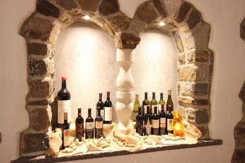 a bunch of wine bottles on a shelf at Hotel Rosalpina in Soraga