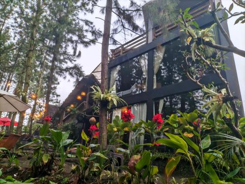 a house with flowers in front of it at Omah kayu bromo in Ngadisari