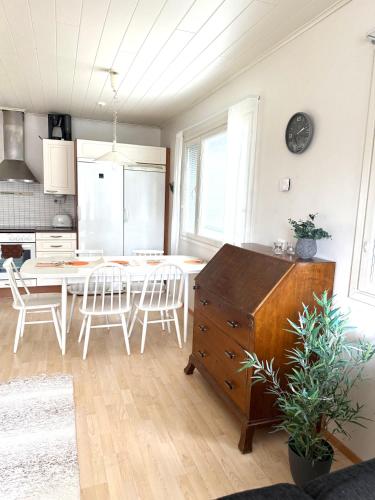 a kitchen and dining room with a table and chairs at Polar Night Wooden House with Sauna in Sodankylä
