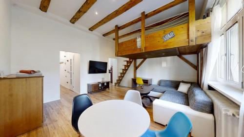a living room with a couch and a table at Old Town Loft in Žilina