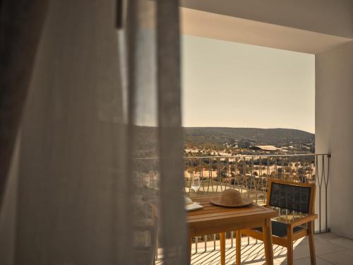 a room with a table and a window with a view at Viceroy at Ombria Algarve in Loulé