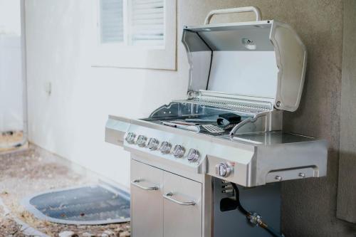 a silver stove top oven sitting in a kitchen at 5040 Sqft l Sleeps 25 l Near Ski & Downtown SLC in West Jordan