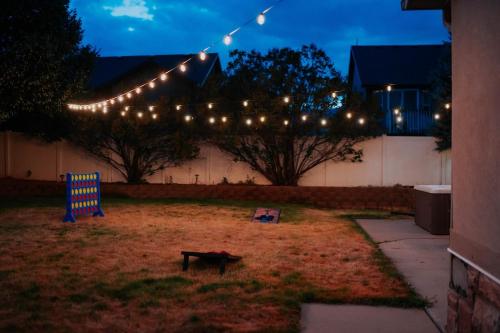 a yard with a string of lights and a bench at 5040 Sqft l Sleeps 25 l Near Ski & Downtown SLC in West Jordan