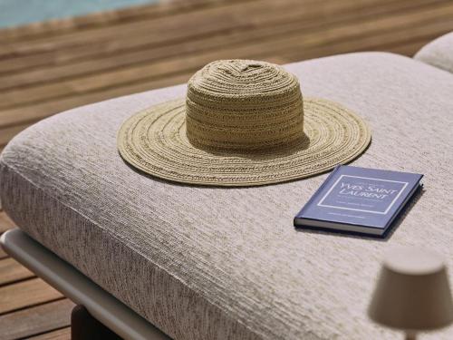a straw hat sitting on a table with a book at Villa Kailani in Adeje