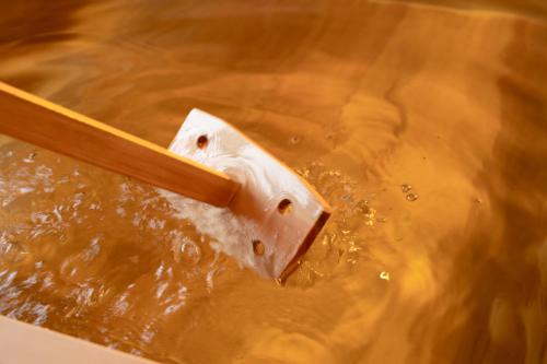 a wooden object sticking out of the water at 旅庵 川喜 in Omachi