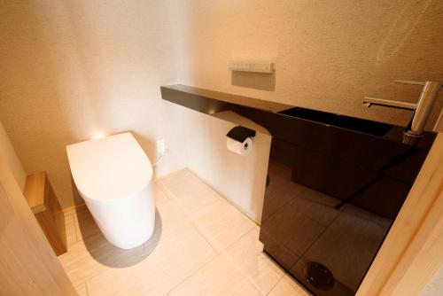 a bathroom with a white toilet in a room at 山人 Oga in Oga
