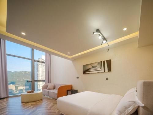 a bedroom with a bed and a large window at Ouchen International Sky River Hotel (Monument to the people's Liberation Pedestrian Street Store, Chongqing) in Chongqing