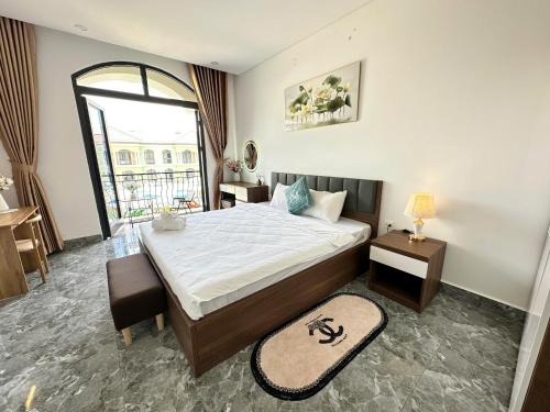 a bedroom with a large bed and a window at Moc Lam Homestay GrandWorld Phu Quoc in Phu Quoc