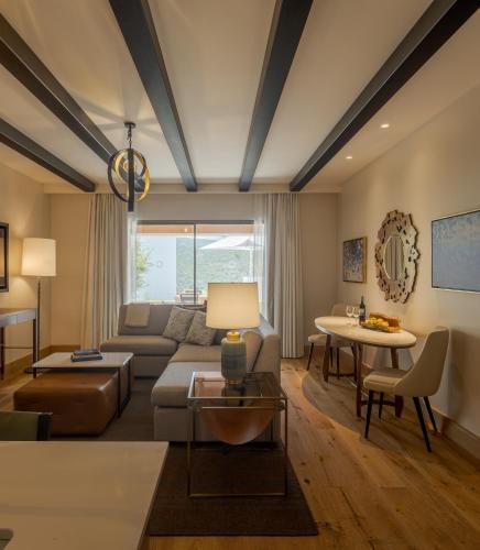 a living room with a couch and a table at Viceroy at Ombria Algarve in Loulé