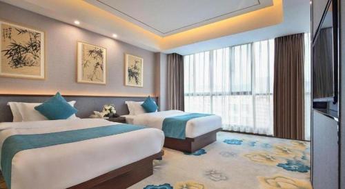 Postel nebo postele na pokoji v ubytování PARK INN KUNMING AIRPORT